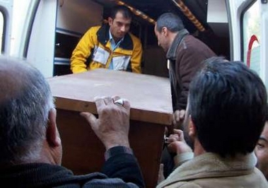 Coffin of 14-year-old Turkish boy Mehmet Ali Kocyigit is taken into an ambulance from a hospital before burial in the eastern city of Van in Turkey, January 4, 2006.