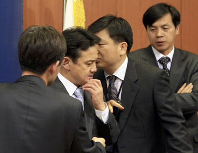 South Korean foreign ministry officials talk at the ministry's main office in Seoul April 17, 2007, after it was reported the gunman who killed 32 people and then himself at Virginia Tech university on Monday was identified by police as Cho Seung-Hui, a South Korean studying at the university. Police said Cho was 23 and was studying English literature. They gave no motive for the shooting rampage, the worst in US history.