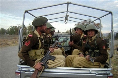 Pakistani paramilitary troops patrol at Mir Ali in Pakistan's tribal area of North Waziristan, along Afghanistan's border March 7, 2006. (AP